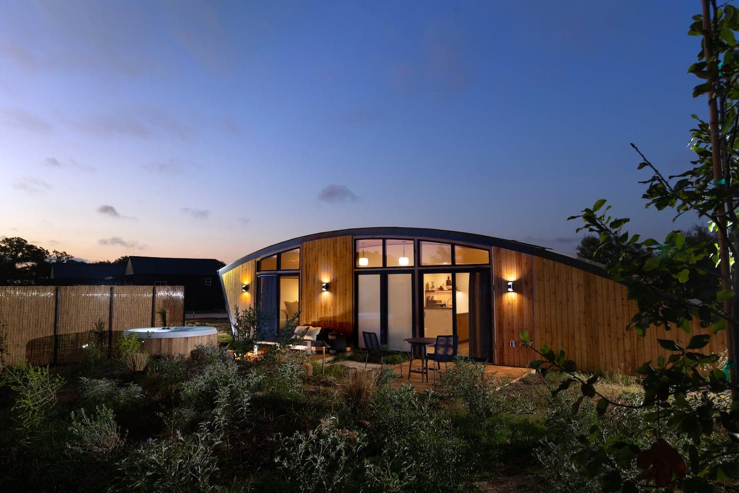 Cascade's sweeping wave-shaped cedar roof lit at twilight