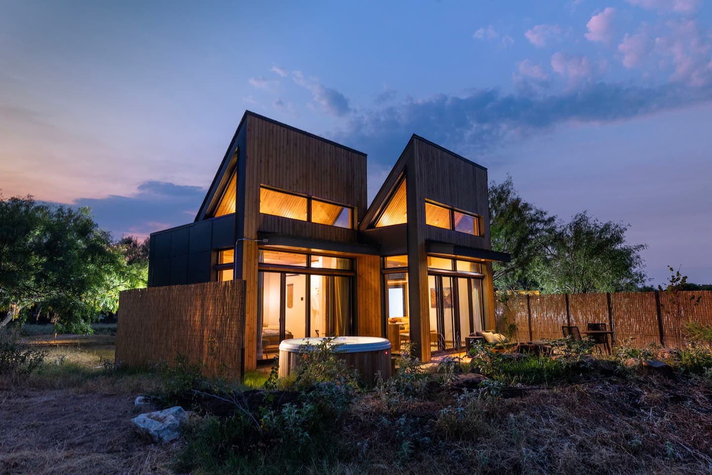 Suncatcher's twin timber gables against a pink sunset sky