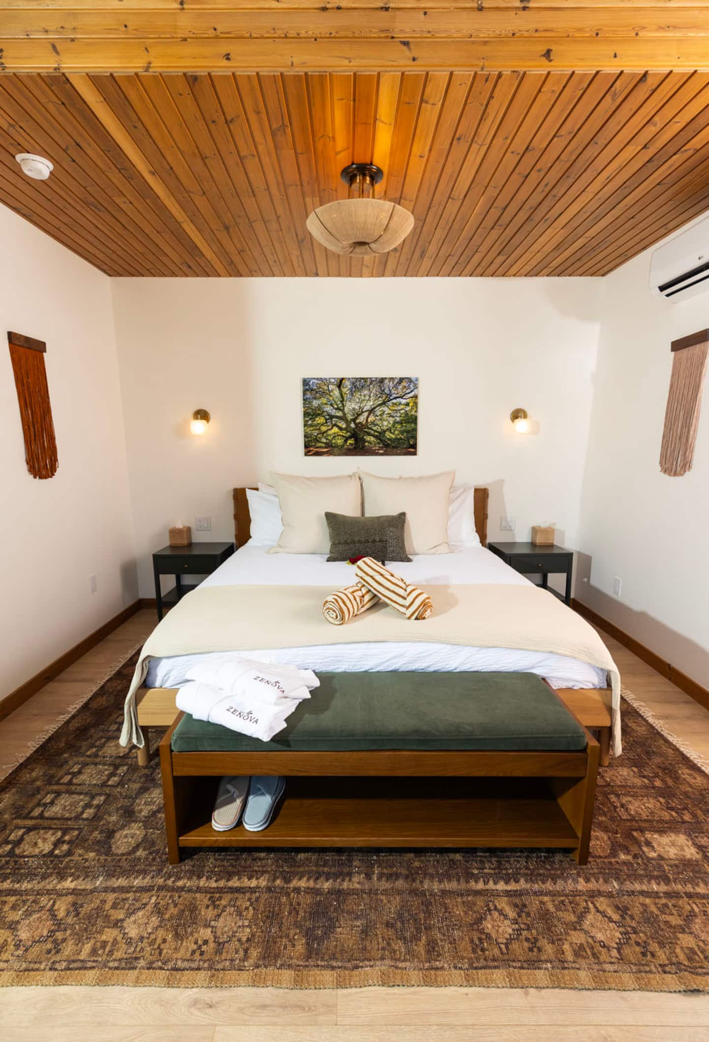 A villa bedroom with cedar ceiling, Zenova robes and slippers set out
